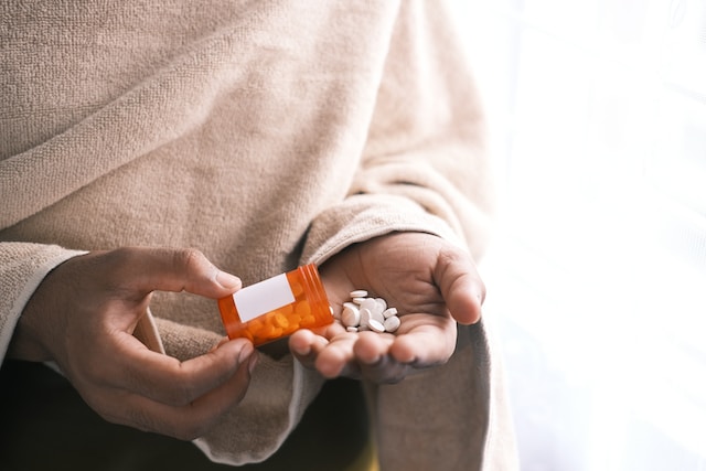 a man taking pills out of a case