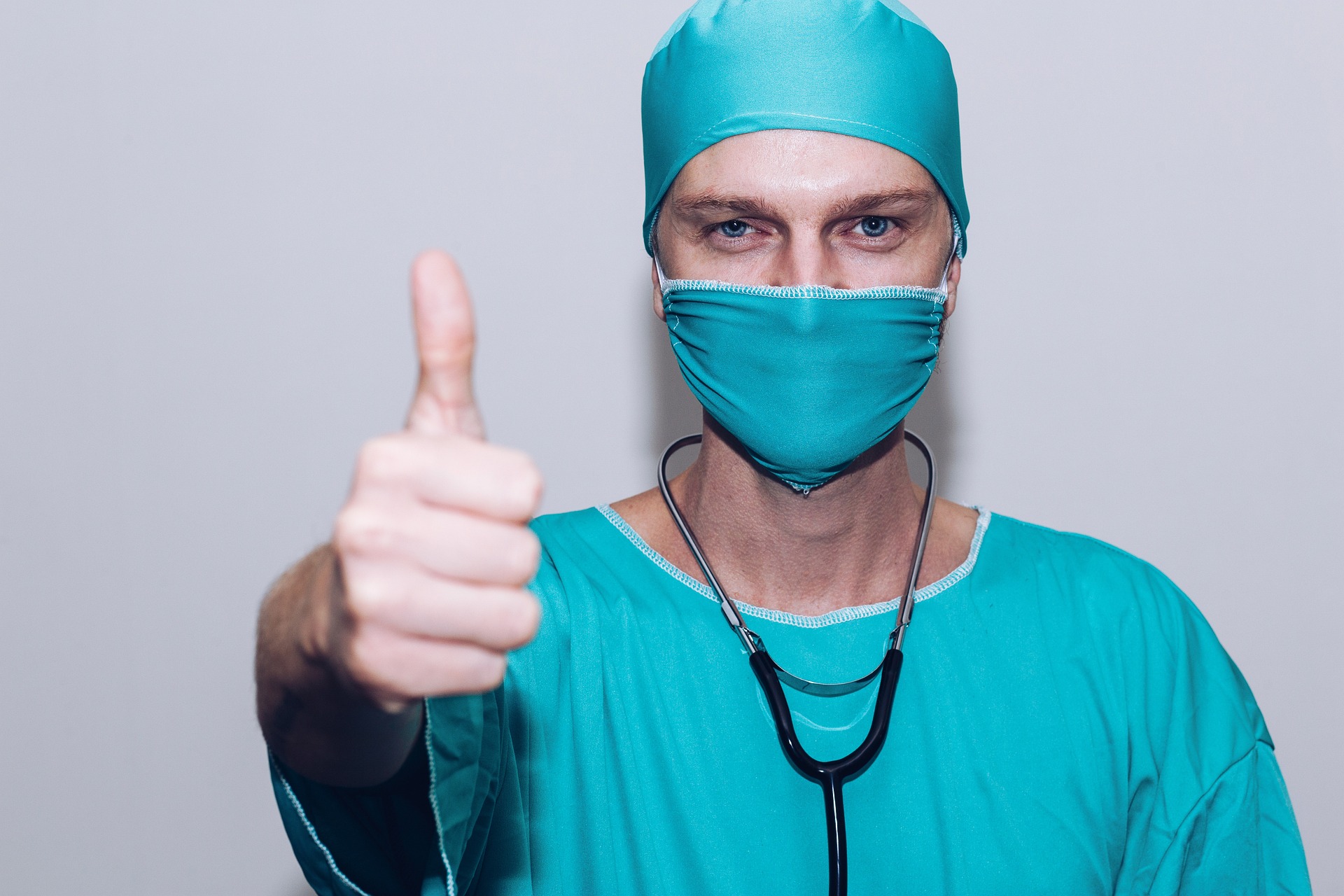 A medical practitioner giving thumbs up