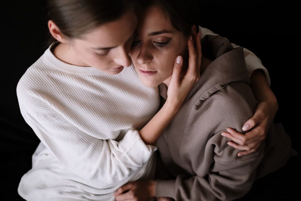 Two people side hugging