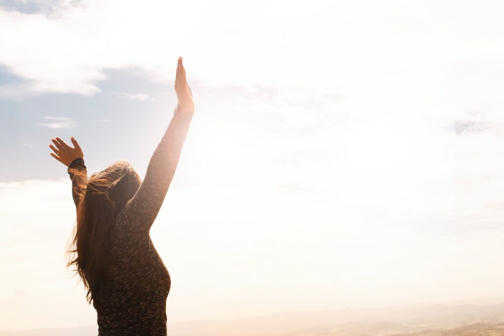 A woman raising her hands in the air