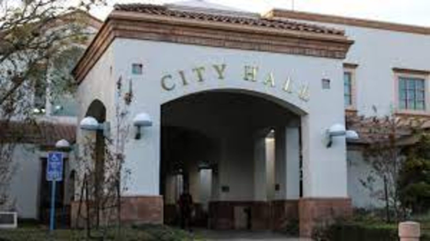 A building in Orange County with a City Hall sign on it.