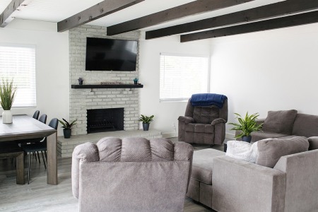 A cozy living room with fireplace and flat screen TV.