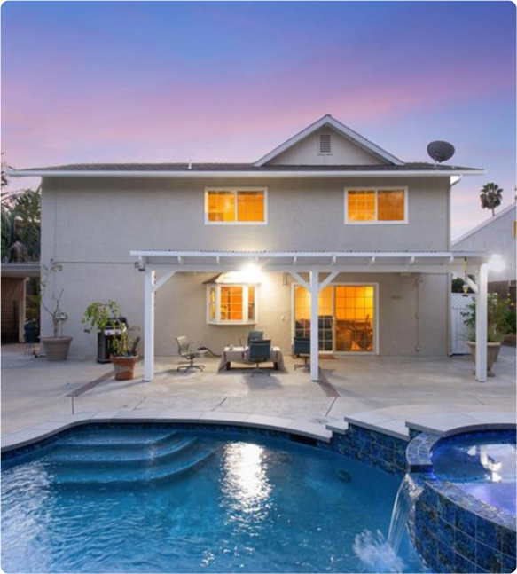 A beautiful home with a pool and patio area, perfect for relaxation and outdoor gatherings.