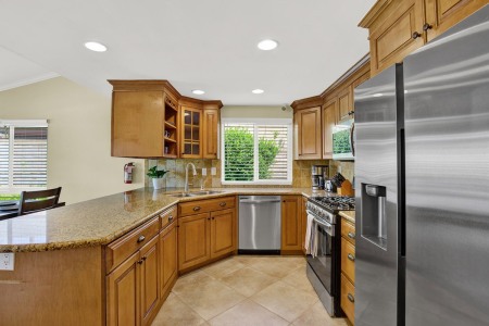 A modern kitchen with sleek stainless steel appliances and elegant wood cabinets.