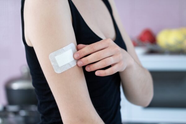 Hangover patch on the upper arm of a woman
