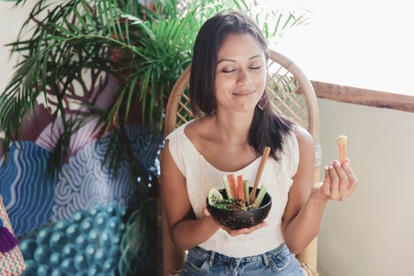 Young woman mindfully eating a veggie bowl