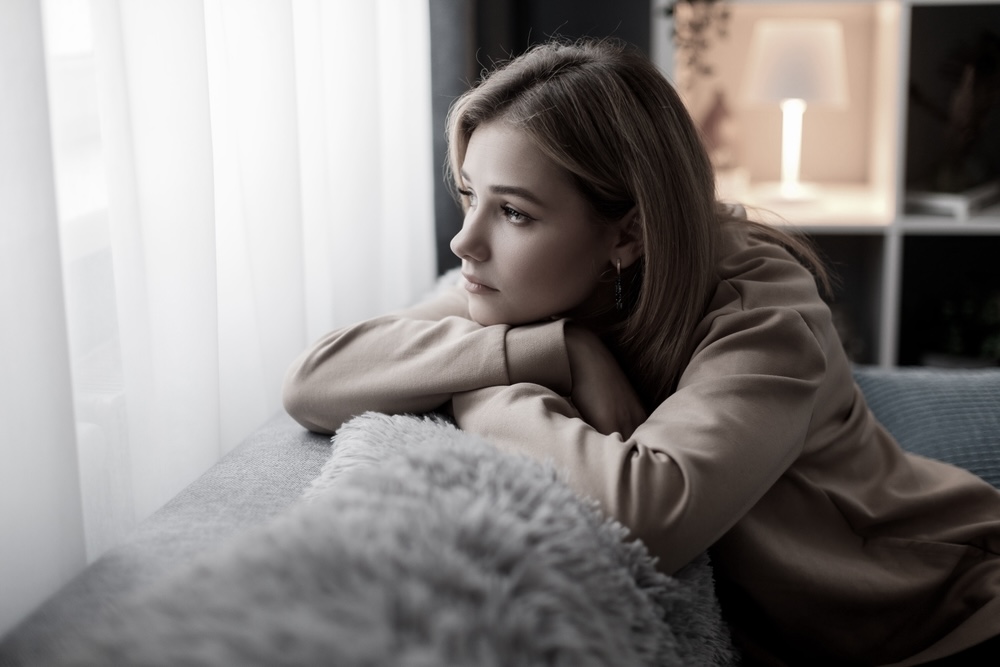 Woman on the couch looking out the window