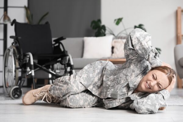 Female soldier on the floor struggling with PTSD symptoms