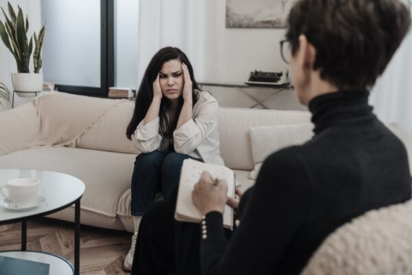 Woman struggling with mental health problems speaking to a therapist in IOP