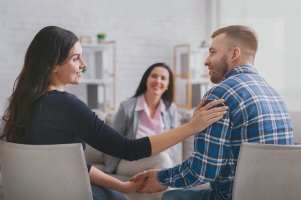 Couple smiling at each other during family therapy session