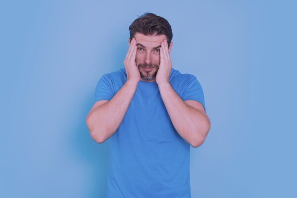 Man holding his head feeling the side effect of marijuana edibles