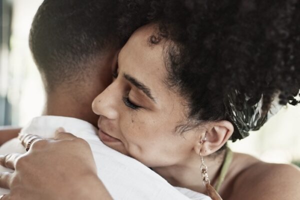 Woman hugging her partner in addiction treatment