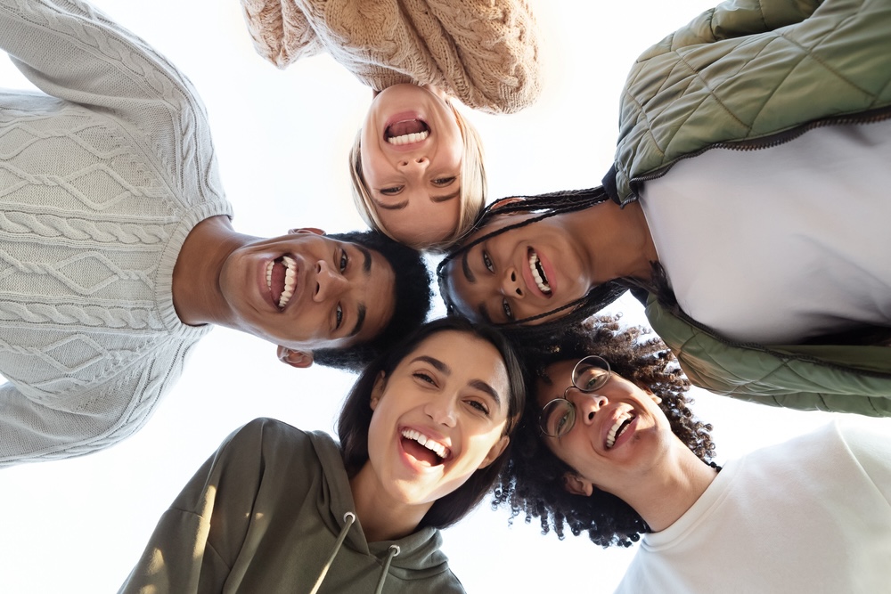 Group of young people in a circle happy and smiling