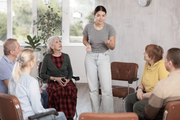 Woman talking to a group of people
