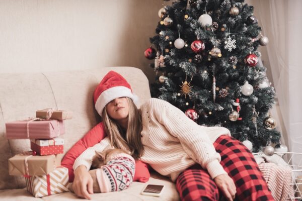 Woman asleep on the couch from tiredness during holiday rush