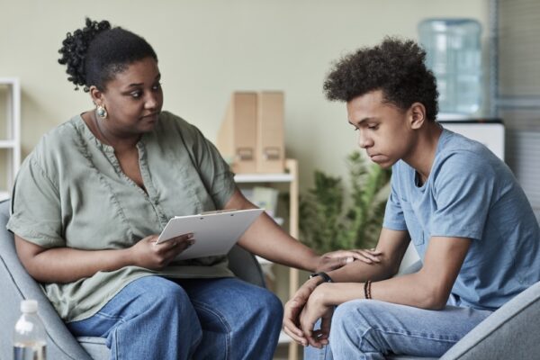 Young male teen getting individual counseling for marijuana use disorder