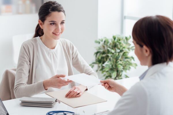 Woman receiving a prescription from an addiction specialist