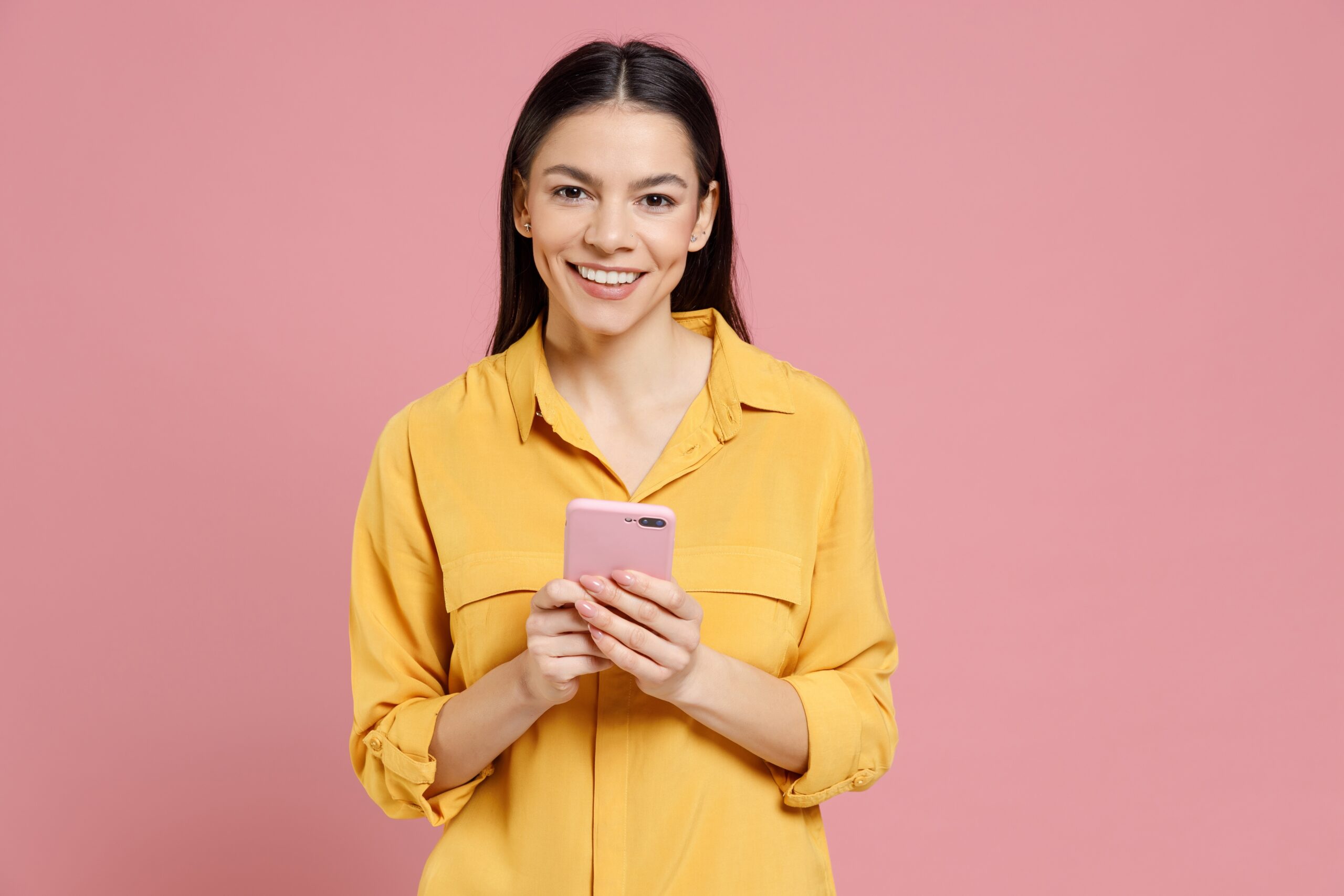 Man in a blue shirt reading sobriety congratulation messages Woman in yellow top reading a congratulations message on sobriety on a phone