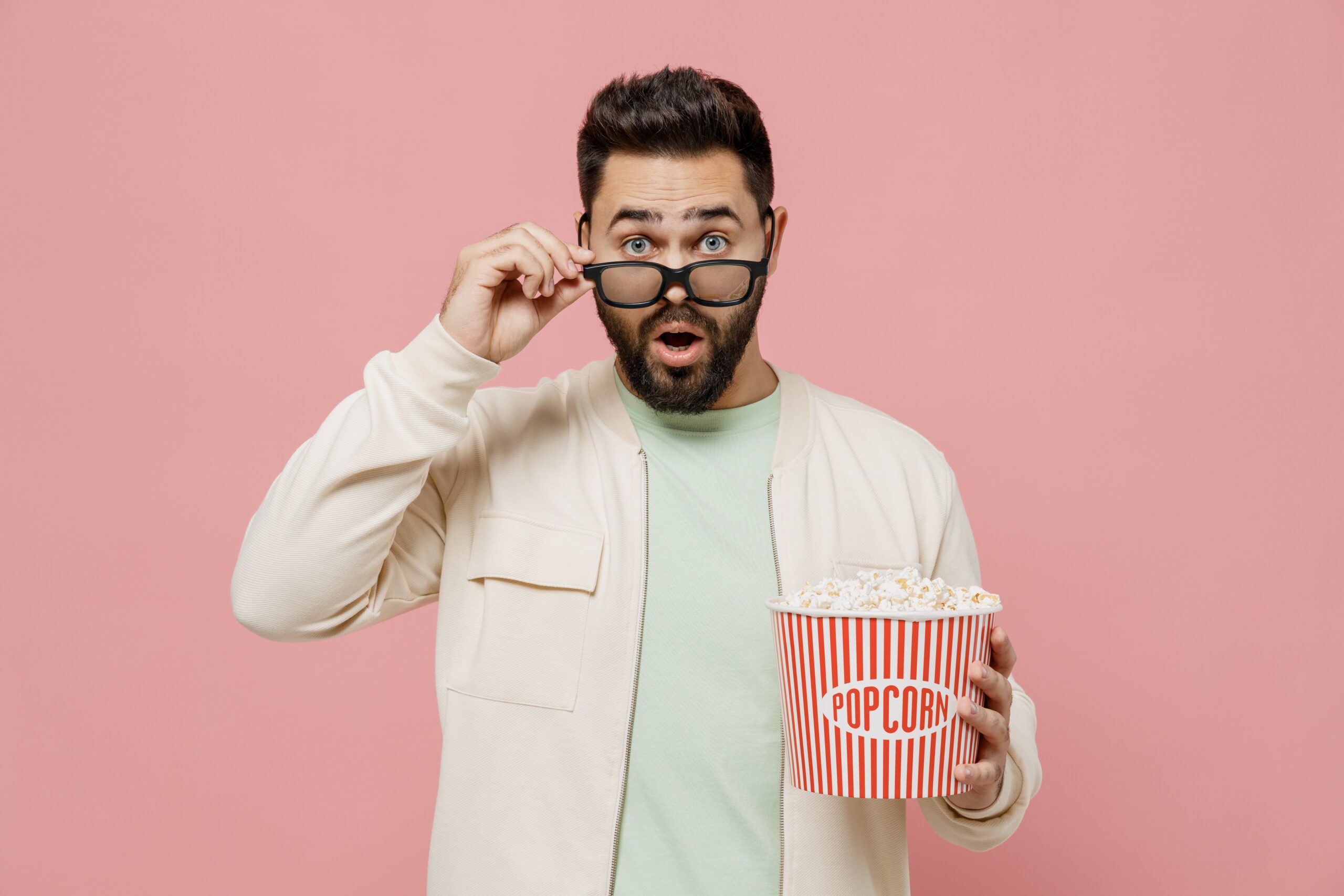 Man holding a popcorn to watch addiction movies on recovery