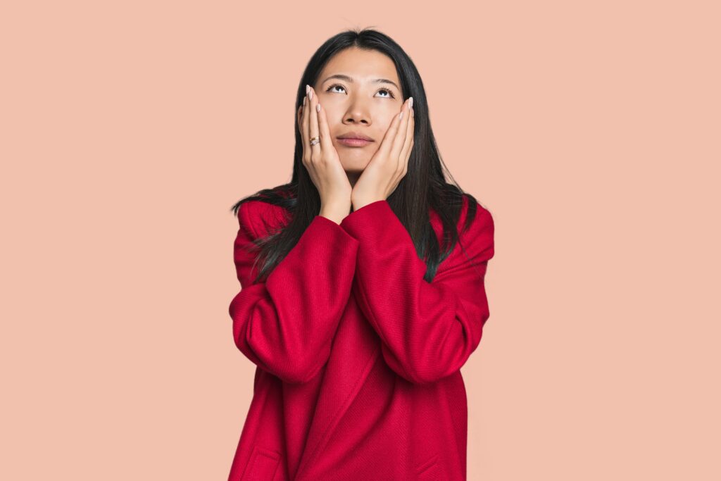 Woman in red sweater experiencing relapse due to heartbreak