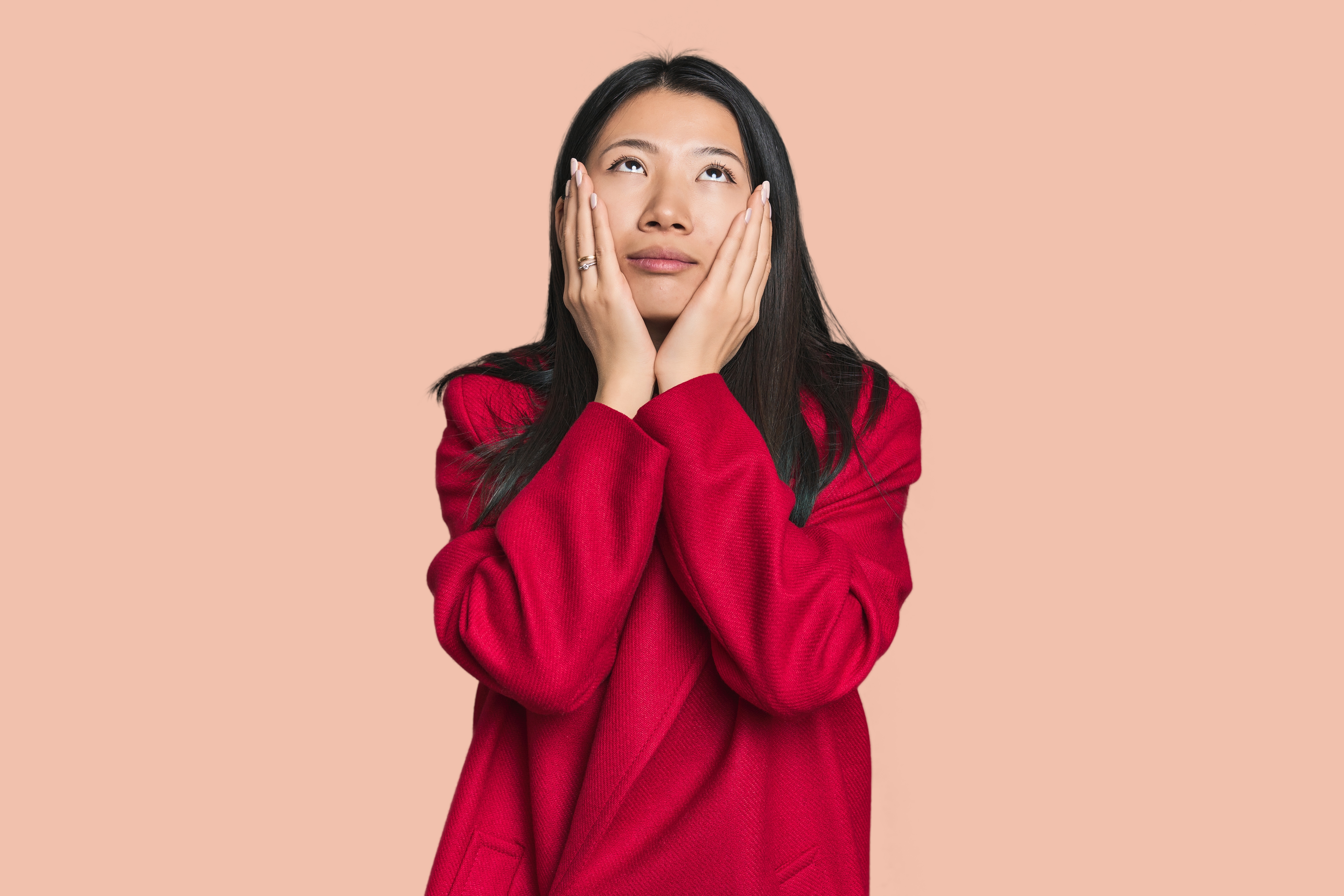 Woman in red sweater experiencing relapse due to heartbreak
