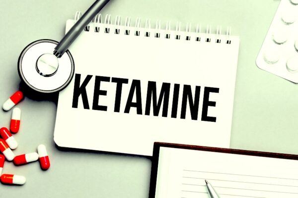 Doctor’s table with a notepad with the drug name ketamine written on it
