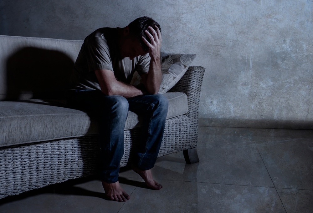 Man on a couch who relapsed after going to rehab