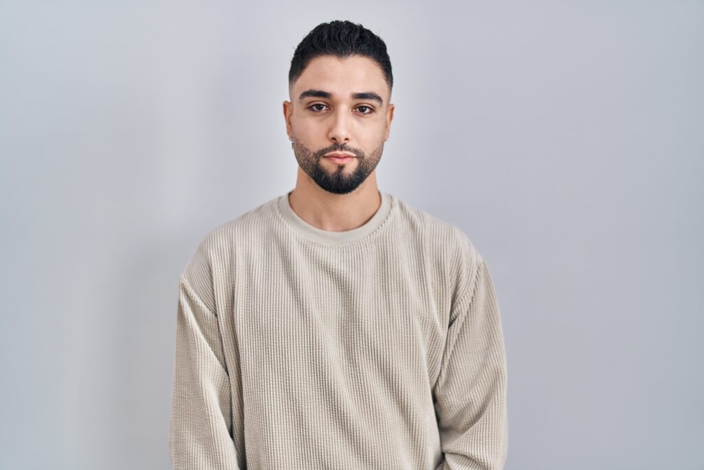Male in beige sweater sad and depressed while recovering from addiction