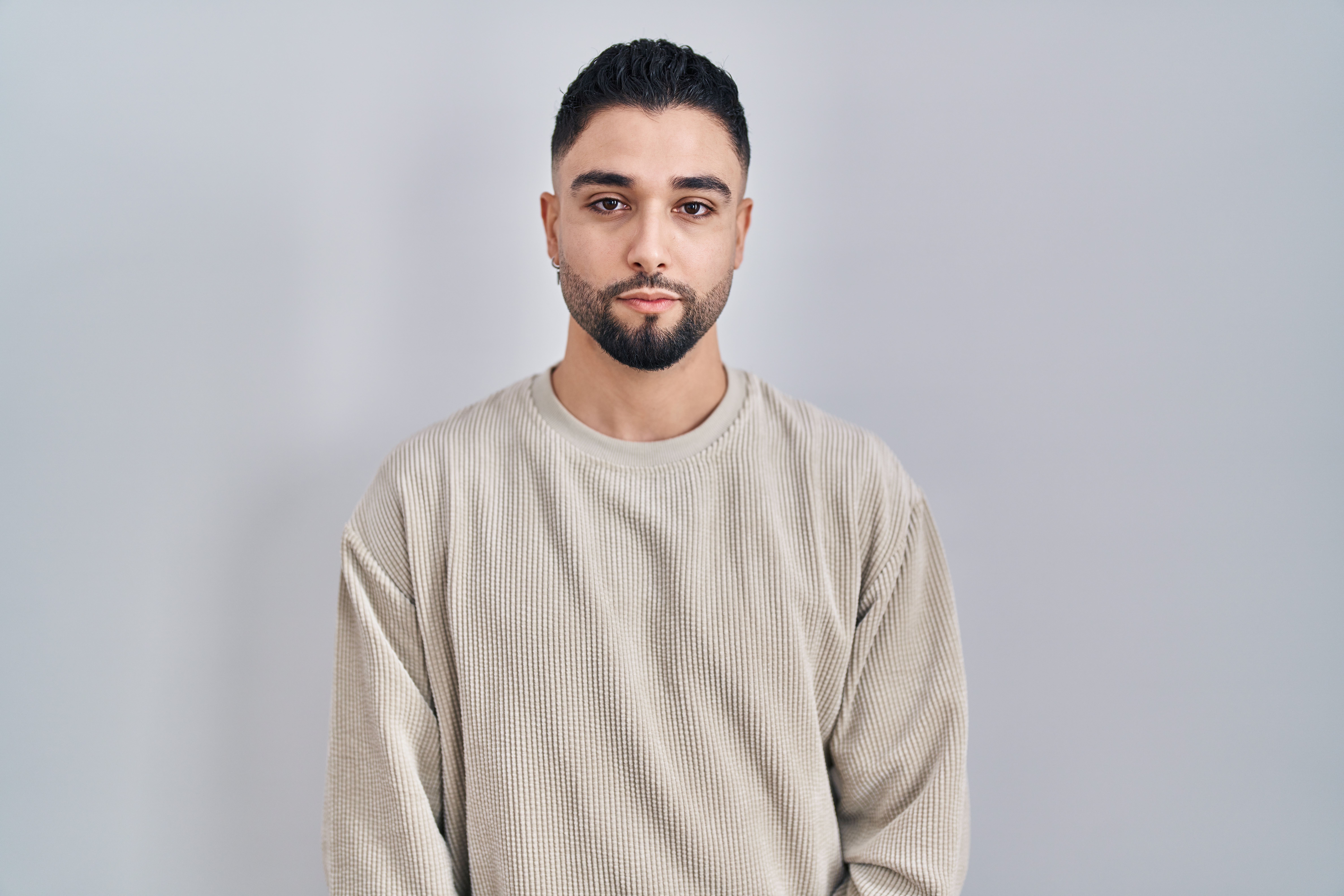 Male in beige sweater sad and depressed while recovering from addiction
