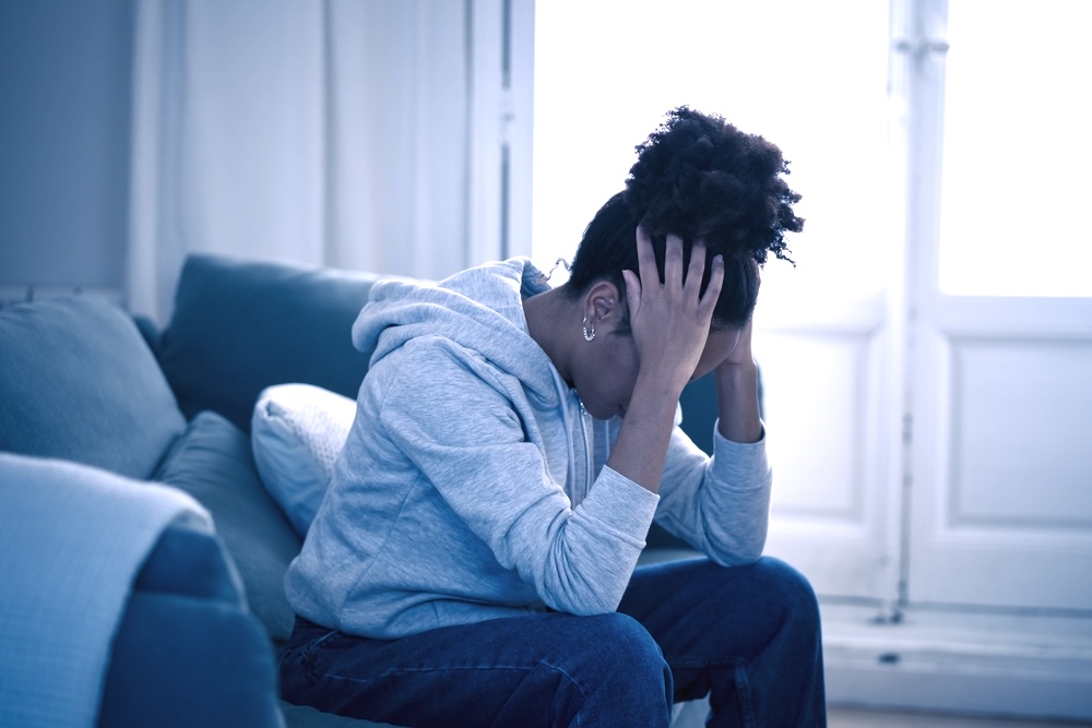 Woman on a couch struggling with drug cravings