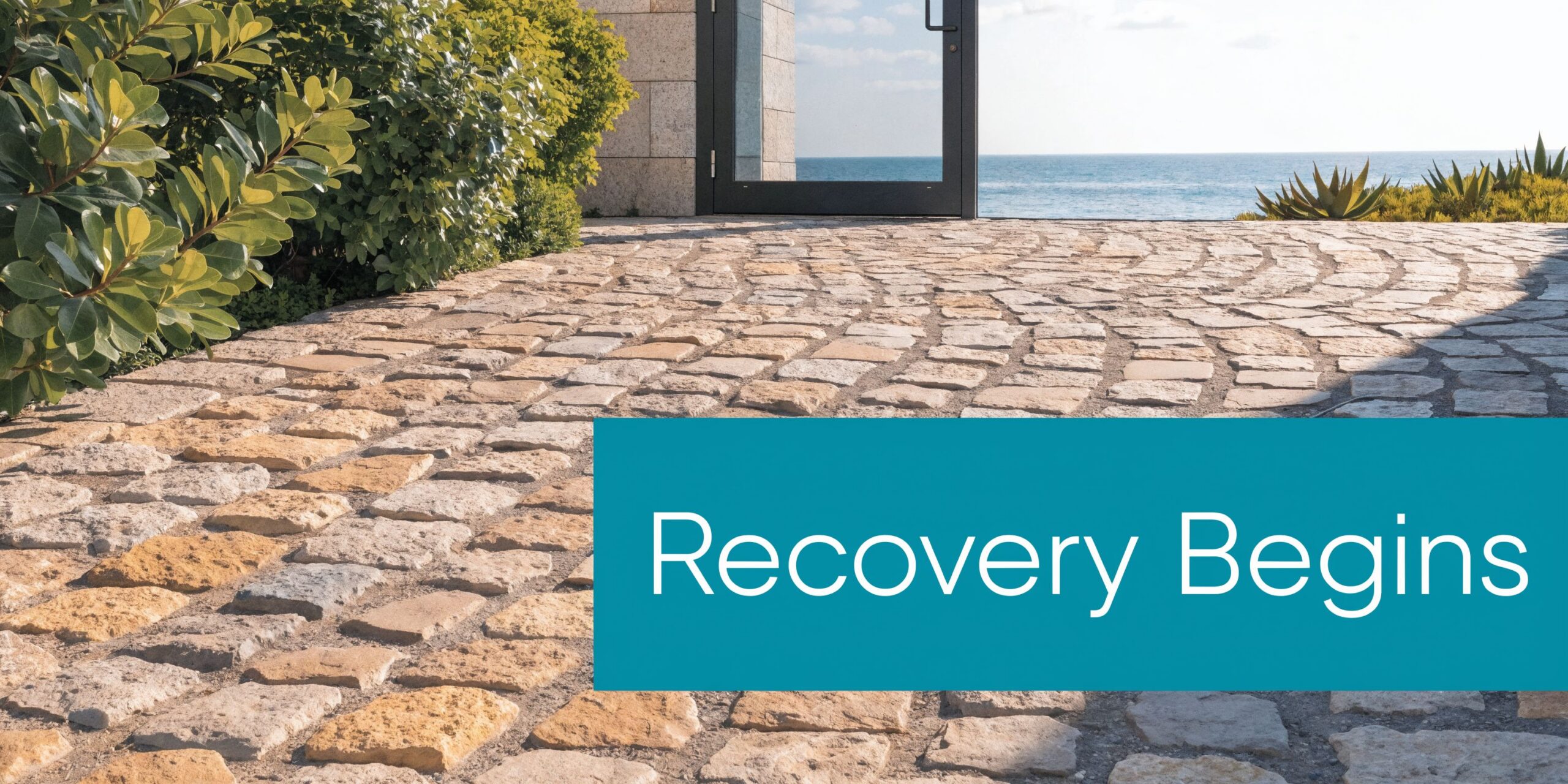 A stone pathway leads to a glass door overlooking the ocean with the text Recovery Begins.