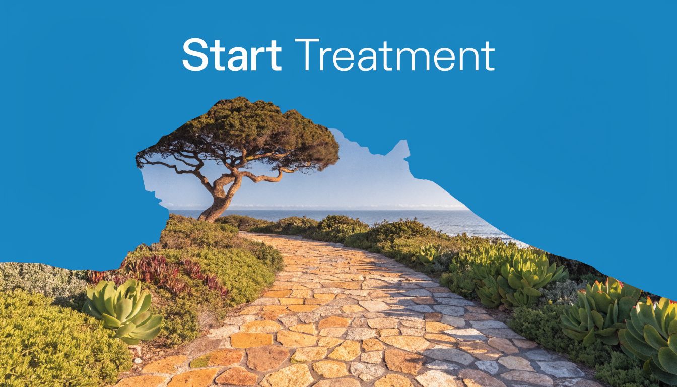 A stone pathway leads toward a serene ocean view with a lone tree under clear blue skies.