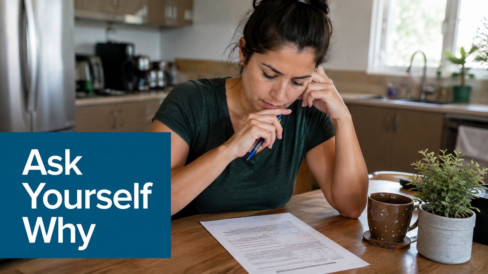A woman sits at a kitchen table looking thoughtfully at a co-dependent worksheet while holding a pen.